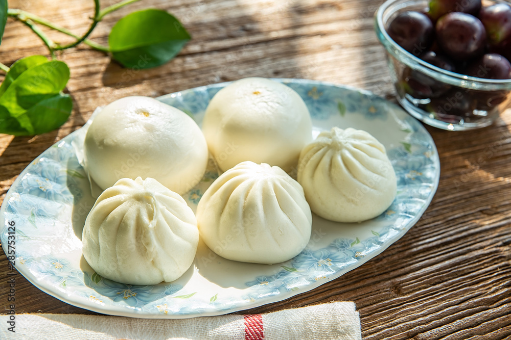 Fototapeta premium The morning sun shines on the nutritious breakfast on the wooden table.