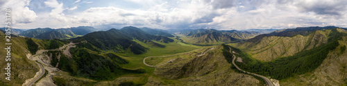 A landscape view of beautiful fresh green forest, road Chui tract and Altai mountain background. Panoramic view of beautiful green forest in the Altai mountains