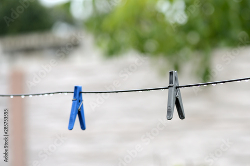 Plastic clotheslines with water drops after rain close up