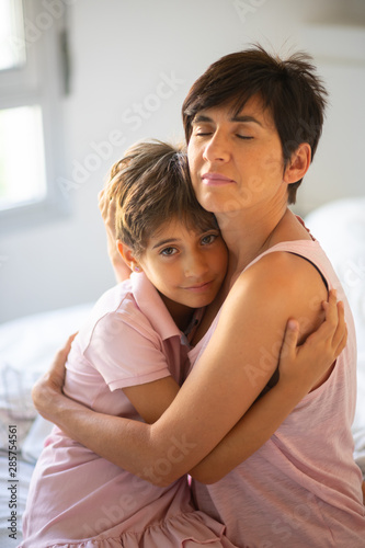 Free Download Beautiful young woman and her charming little daughter are hugging. - GFXLoad