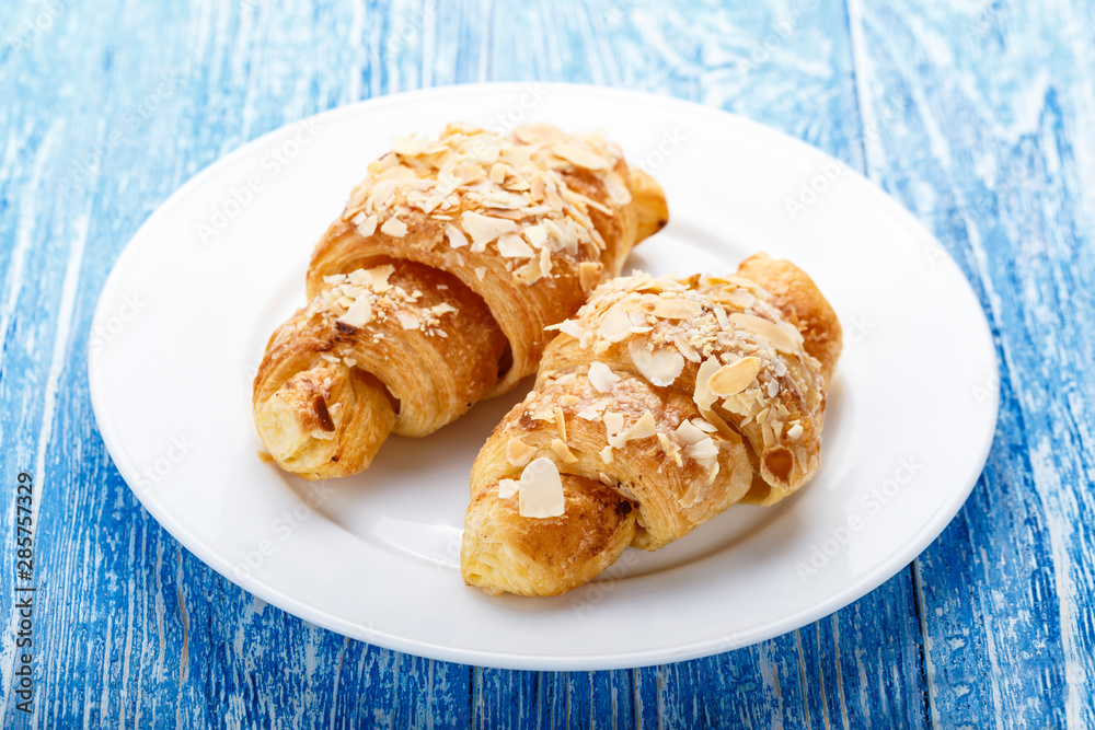 two croissants in a plate two croissants in a plate