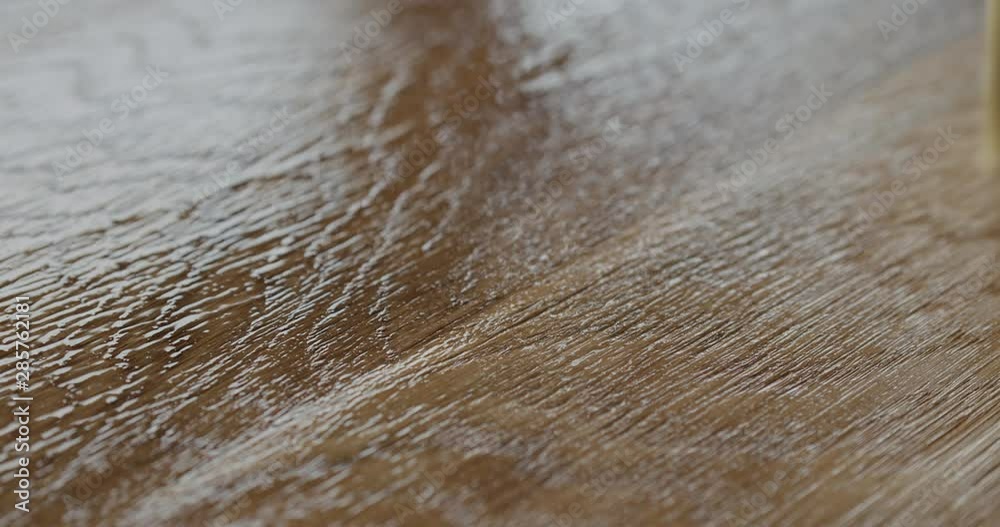 Slow motion applying oil finish to oak surface with brush Slow motion applying oil finish to oak surface with brush
