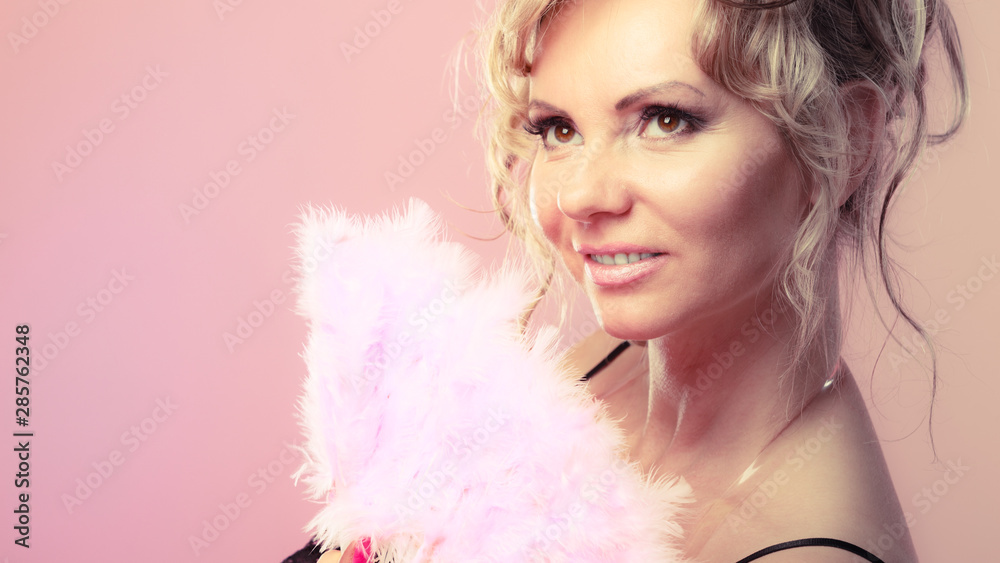 Woman holding carnival feather fan in hand. Woman holding carnival feather fan in hand.