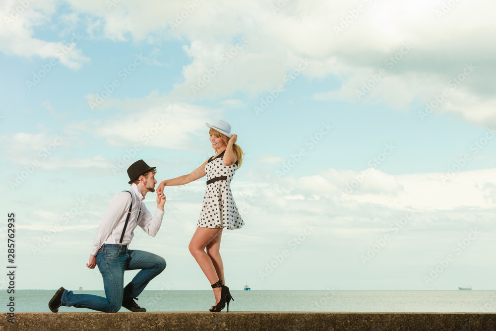 Loving couple retro style dating on sea coast