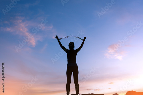 silhouette woman breaking metal chains