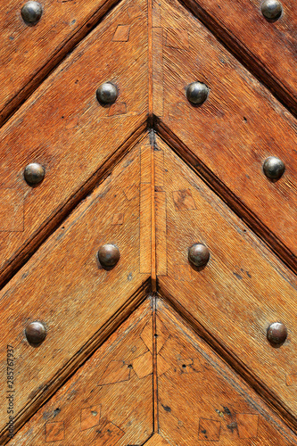 Closeup of old vintage wooden doors with metal rivets