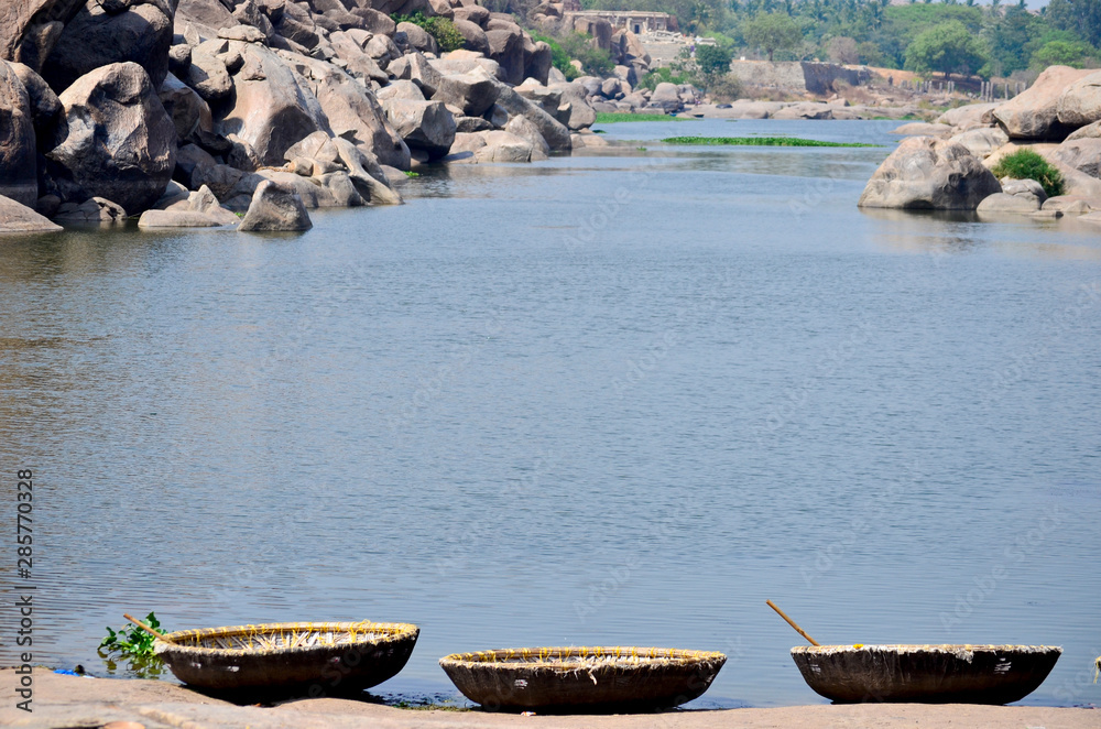 Wicker baskets on the stone in front of de river in Hampi, India