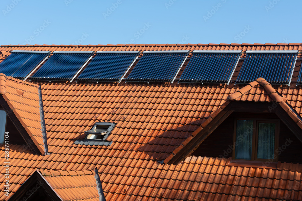 Solar panels installed on red roof Solar panels installed on red roof