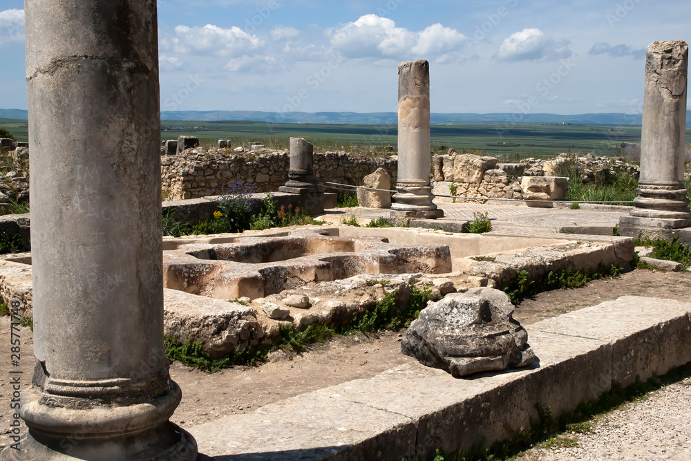 Volubilis Morocco, North Baths roman ruins with fields in background