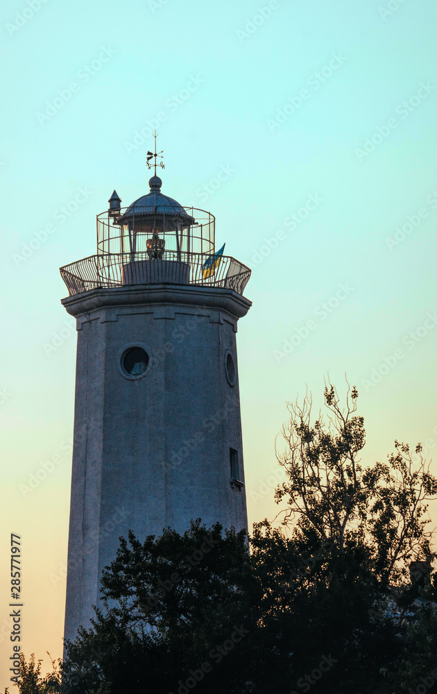 Tower of the old lighthouse against the evening sky. Countryside landscape Tower of the old lighthouse against the evening sky. Countryside landscape