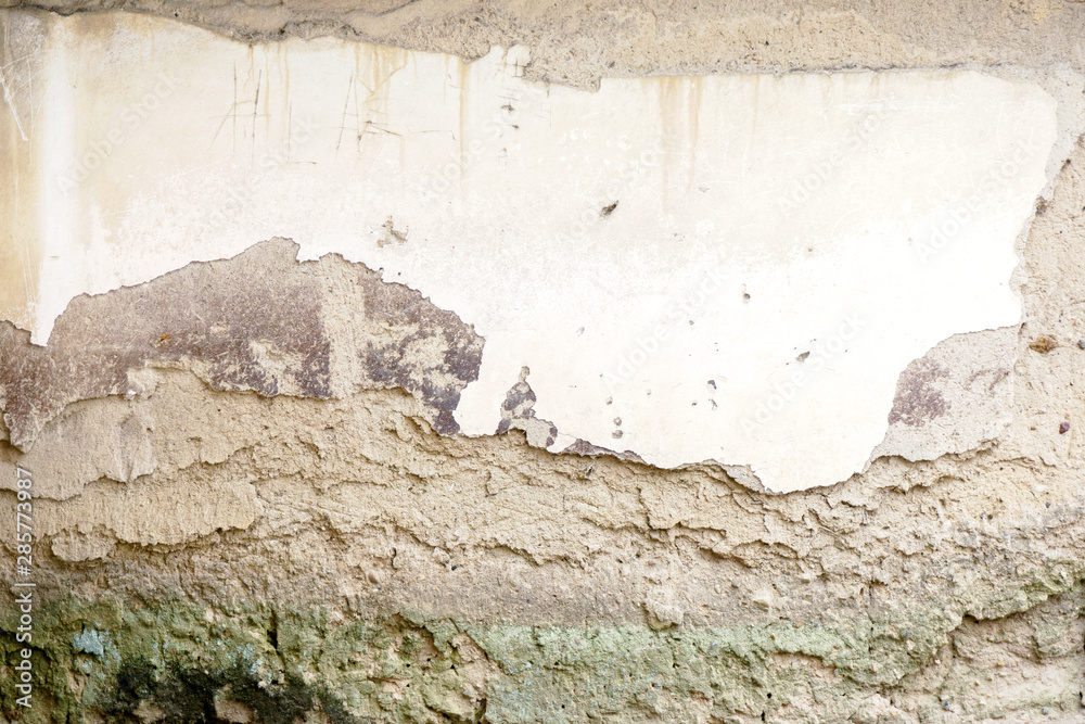 Background and texture of ancient and old house cracked cement wall in natural sun lights.