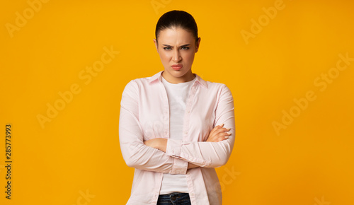 Angry Young Woman Frowning Crossing Hands On Yellow Background