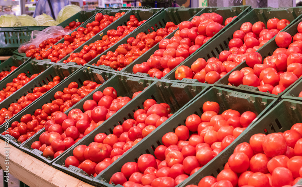 Showcase with tomatoes in a supermarket. A lot of red tomato. The choice of products. vegetables