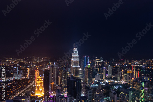 Skyline of Kuala Lumpur during nighttime over viewing illuminated highrise buildings © MXW Photo