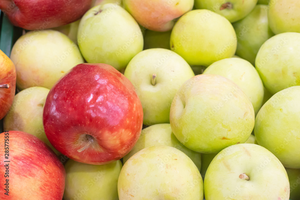 Showcase with apples in a supermarket. A lot of green apples. The choice of products. Fruit Showcase with apples in a supermarket. A lot of green apples. The choice of products. Fruit