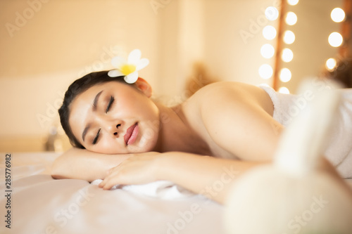 Asian Beautiful  young and healthy woman in spa salon. Massage treatment spa room  . Traditional medicine and healing concept.