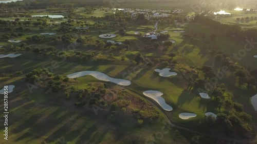 Aerial shot of a golf field in the region of algarve in Portugal on a beautiful sunset photo