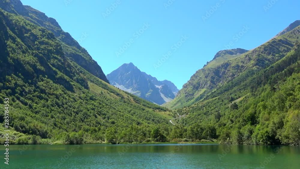 Lake scenes in mountains, national park of Dombay, Caucasus, Russia. Summer landscape, sunshine weather, blue sky and sunny day Lake scenes in mountains, national park of Dombay, Caucasus, Russia. Summer landscape, sunshine weather, blue sky and sunny day
