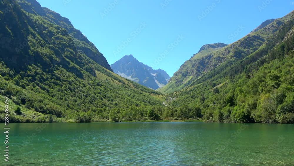 Lake scenes in mountains, national park of Dombay, Caucasus, Russia. Summer landscape, sunshine weather, blue sky and sunny day Lake scenes in mountains, national park of Dombay, Caucasus, Russia. Summer landscape, sunshine weather, blue sky and sunny day