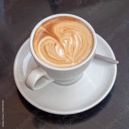 Italian cappuccino coffee cup on wooden table surface