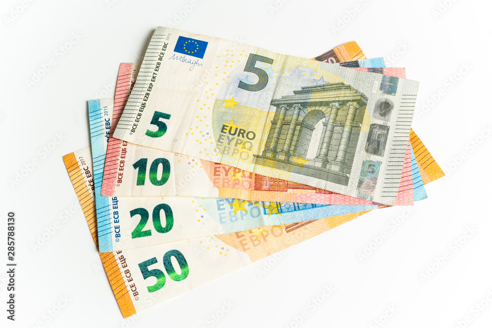 Four Euro bills. Five, ten, twenty and fifty Euros in a waver Four Euro bills. Five, ten, twenty and fifty Euros in a waver