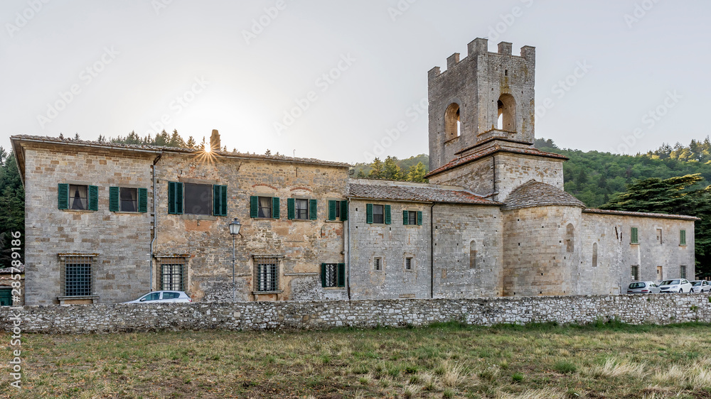 The beautiful Abbey of San Lorenzo in Coltibuono with the sun setting in the background, Tuscany, Italy