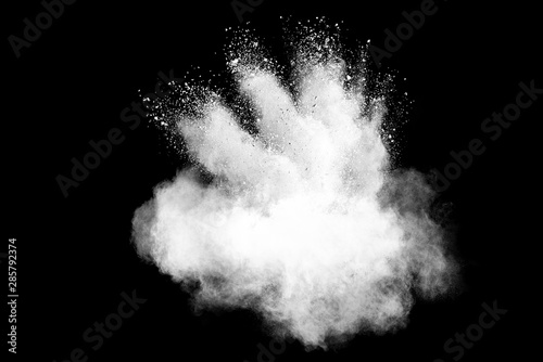 Freeze motion of white color powder exploding on dark background. 