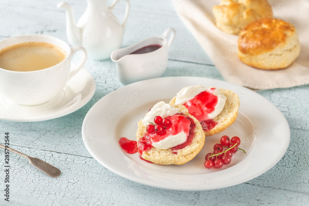 Classic scones with cream and berry jam