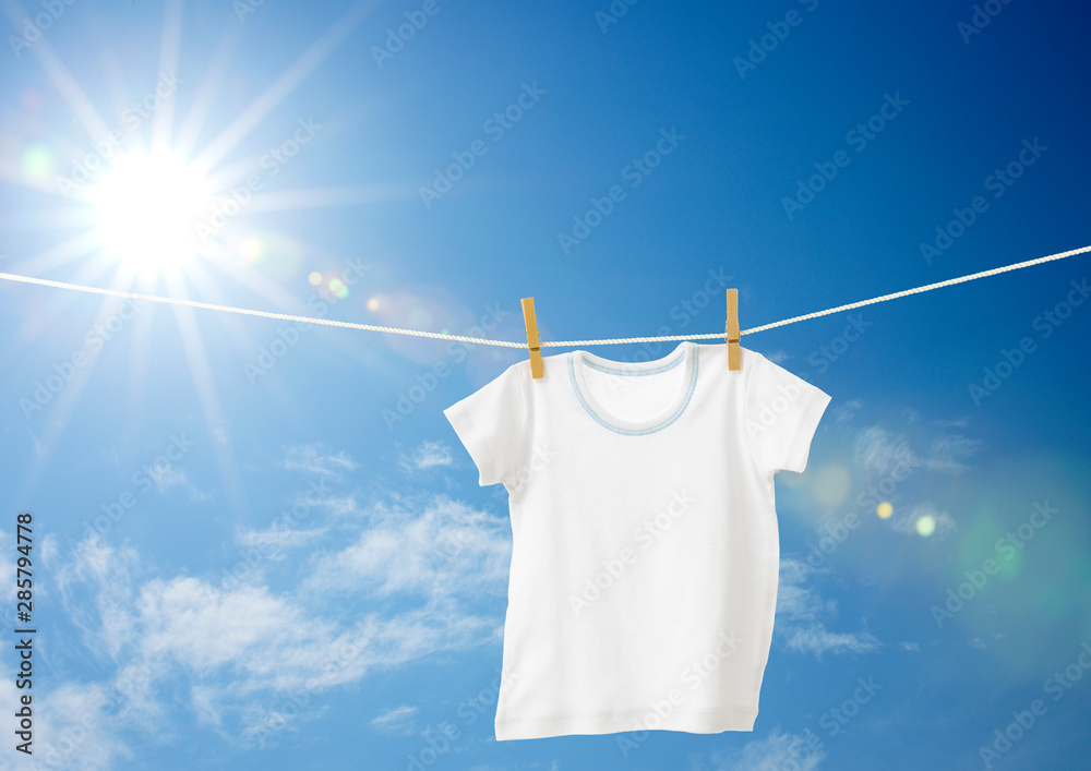 baby clothes hanging on a clothesline - obrazy, fototapety, plakaty 