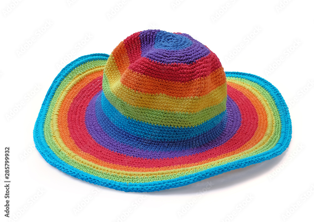 Colorful rainbow rope yarn hat isolated on a white background. Homemade knitted product. Colorful rainbow rope yarn hat isolated on a white background. Homemade knitted product.