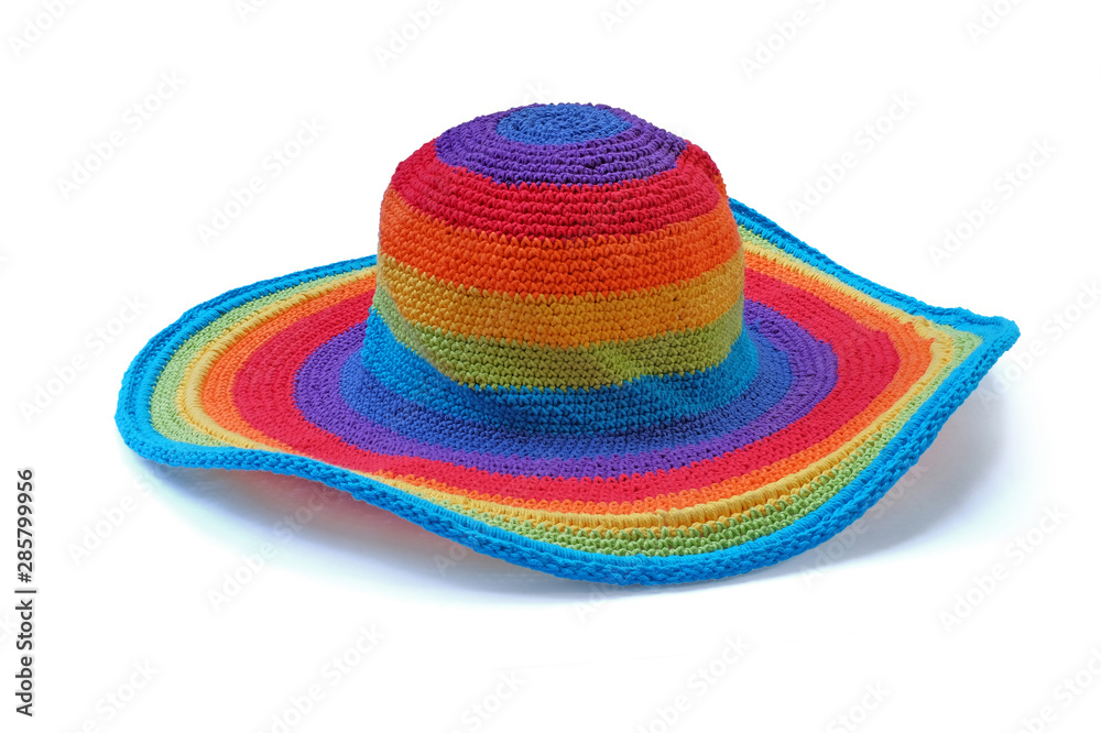 Colorful rainbow rope yarn hat isolated on a white background. Homemade knitted product. Colorful rainbow rope yarn hat isolated on a white background. Homemade knitted product.