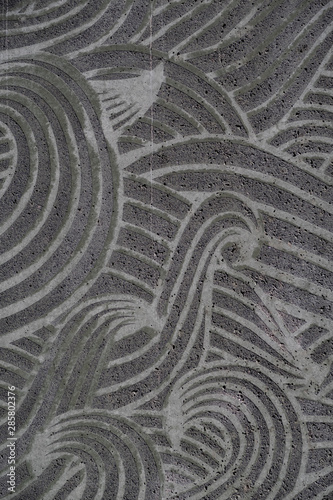 Background: Grey concrete background with swirly pattern