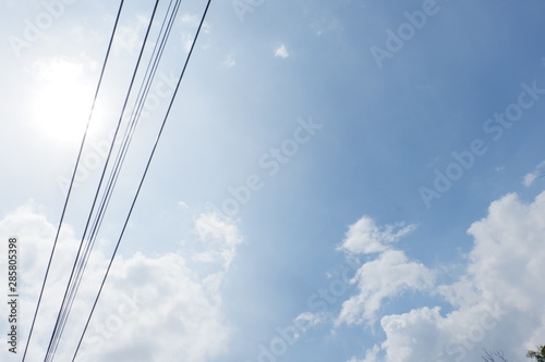 Bright skies with electric wires crossing