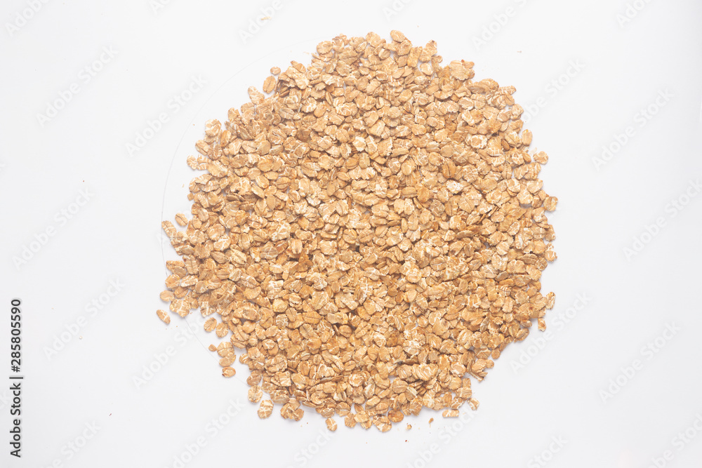 Cereal flakes for granola closeup. Flakes isolated on white background. Nutrition concept. Cereal flakes stock photo. Cereal flakes for granola closeup. Flakes isolated on white background. Nutrition concept. Cereal flakes stock photo.