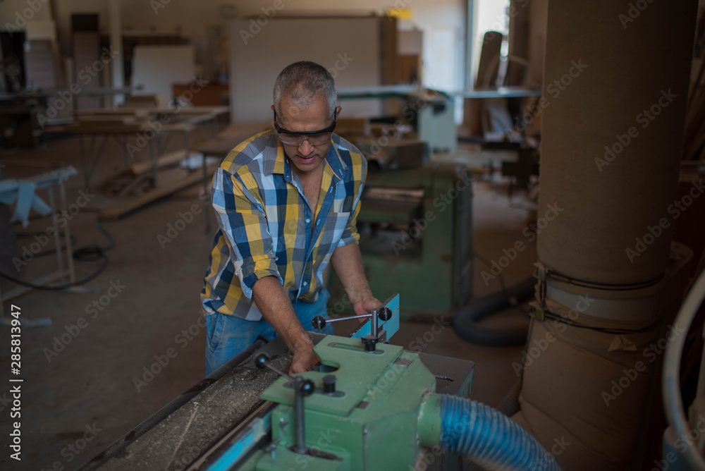 a carpenter processes a massive piece of wood a carpenter processes a massive piece of wood