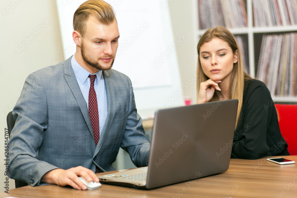 Business people using a laptop computer in their office Business people using a laptop computer in their office