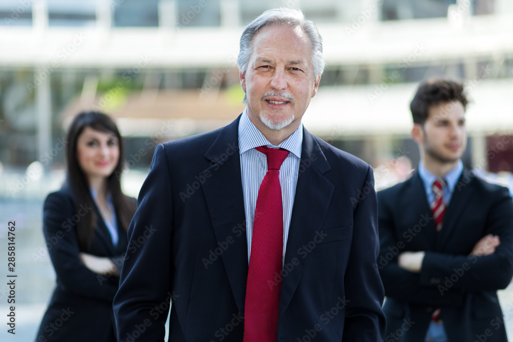 Business team smiling outdoor in a modern urban setting