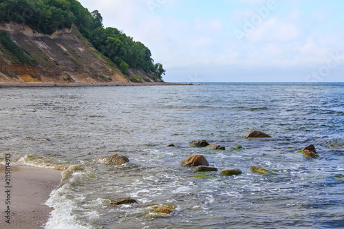 View of the sandy cliffs and a beautiful cove on the Baltic Sea. photo