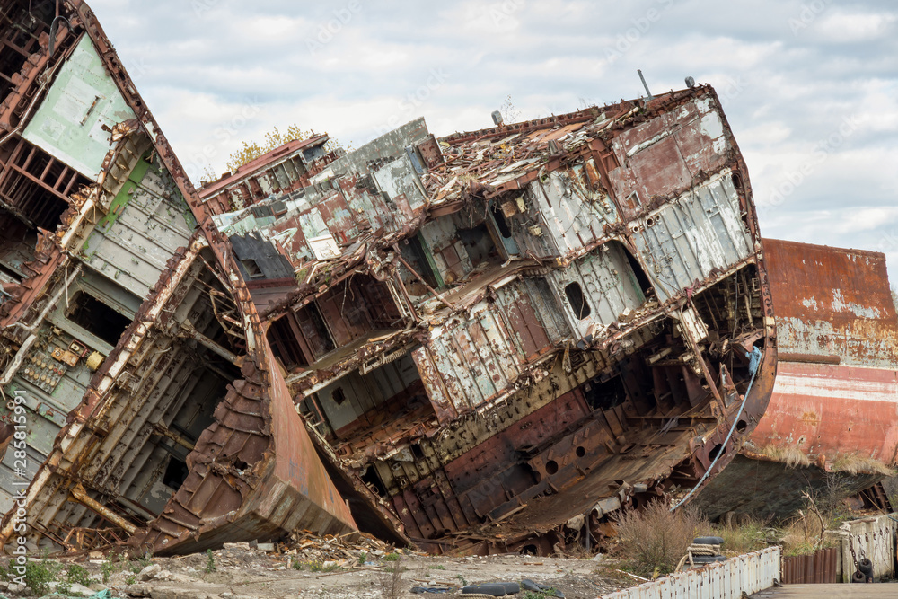 Huge rusty pieces of decommissioned marine ship that was cut and left on the shore. Huge rusty pieces of decommissioned marine ship that was cut and left on the shore.