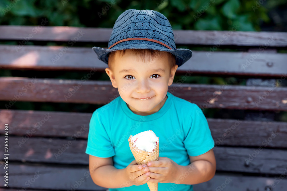 happy smiling toddler boy in blue hat 