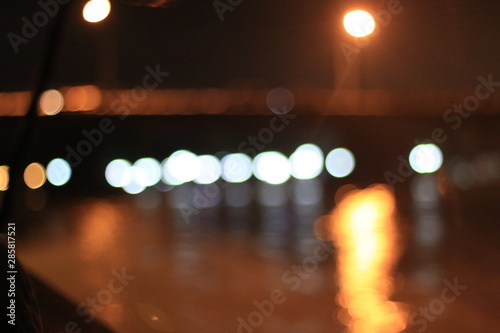 Night twilight blurred bokeh floating market water front, abstract background