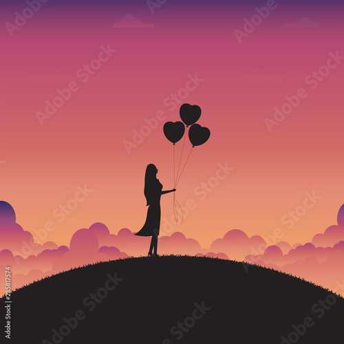 Woman standing holding a heart balloons on sunset background