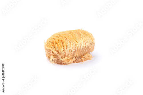 Greek pastry Kataifi with shredded filo dough stuffed with almond nuts, in honey syrup, isolated on white