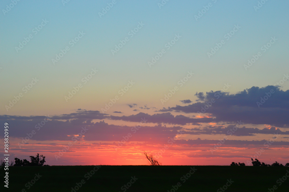 Sunrise over a lush green field in Elk City displays vibrant colors Sunrise over a lush green field in Elk City displays vibrant colors
