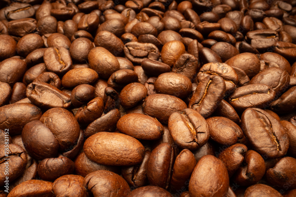 Very big roasted brown coffee beans background Very big roasted brown coffee beans background