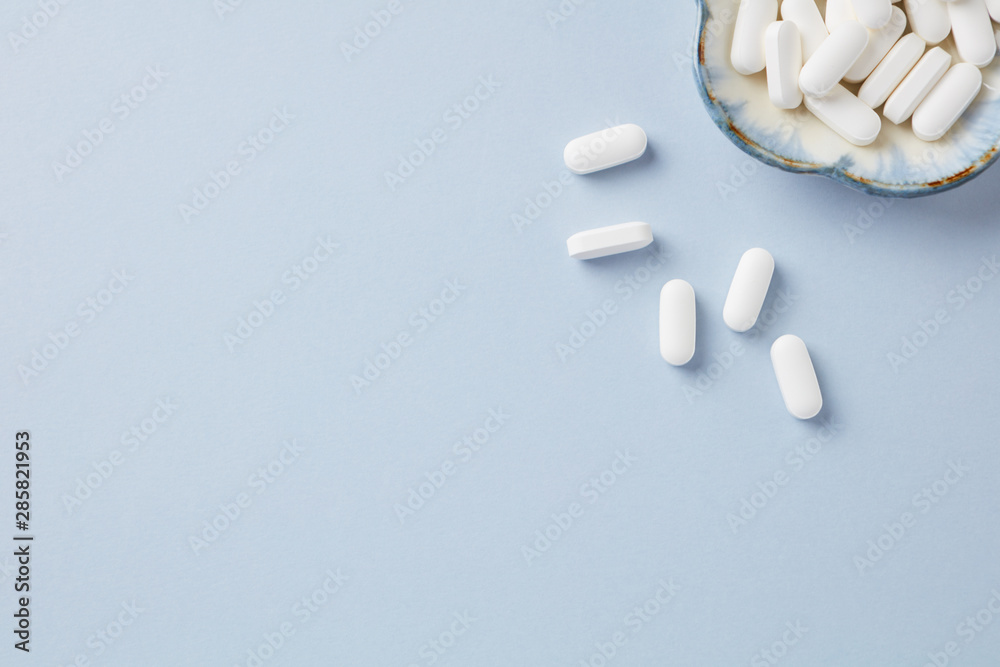 Lysine tablets. Concept for a healthy dietary supplementation. Nervous System Support. Bright background. Top view. Copy space.  