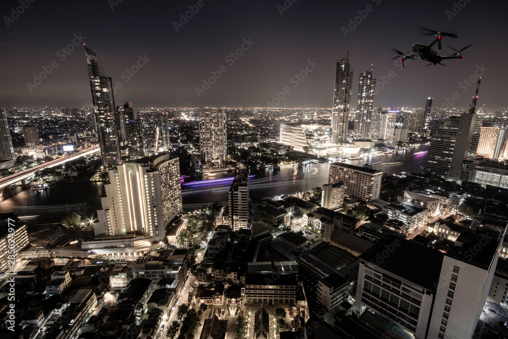 Drone quad copter with high resolution digital camera on the skyline and city background.