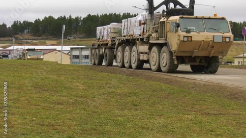 2018 - a U.S. army convoy of soliders and supplies moves along a muddy road in Germany.