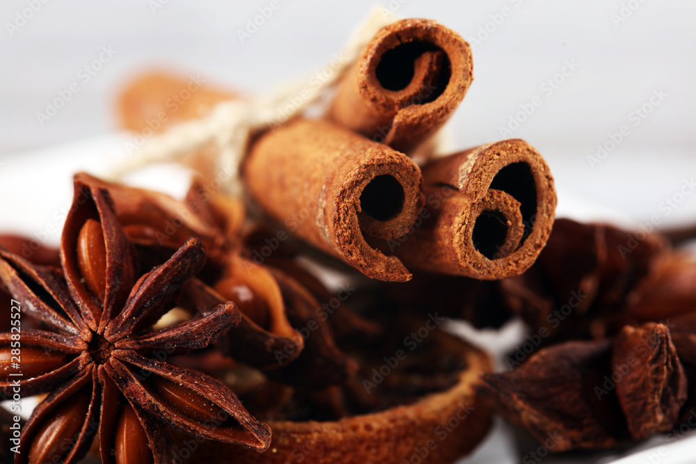 cinnamon, staranise and cloves. winter spices on wooden table - obrazy, fototapety, plakaty 