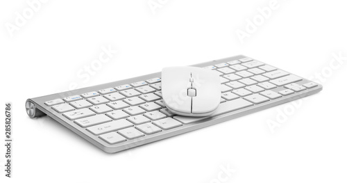 Computer keyboard with mouse on white.